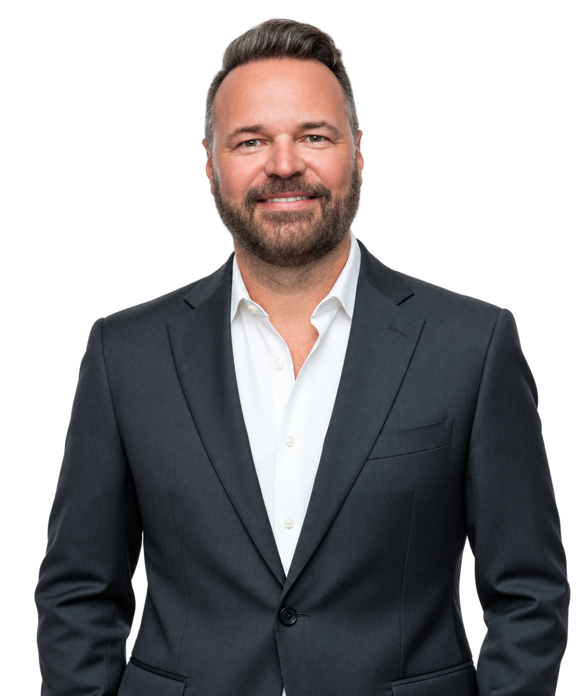 Joe Mathis in a dark suit and white shirt on a transparent background.